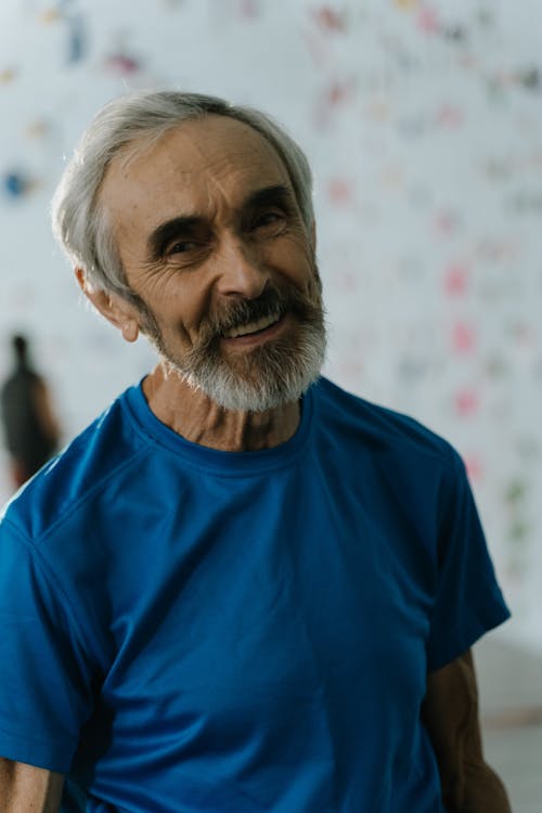 Grey-haired senior man in a blue shirt — relaxed and well-dressed for everyday life